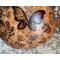 This is a close-up image of butterflies and flowers that have been drawn on a dried gourd. The artwork is drawn using pyrography tools.